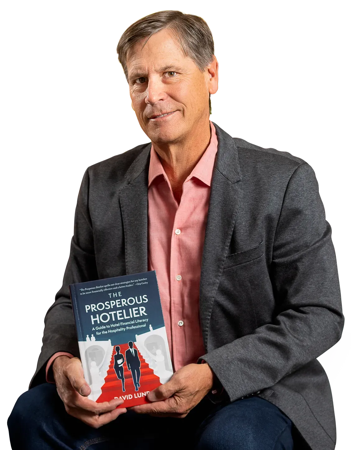 David Lund sitting while holding his book The Prosperous Hotelier